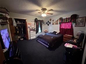 bedroom with a closet, ceiling fan, and a textured ceiling