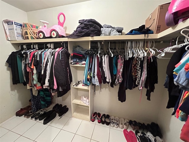 walk in closet featuring tile patterned flooring