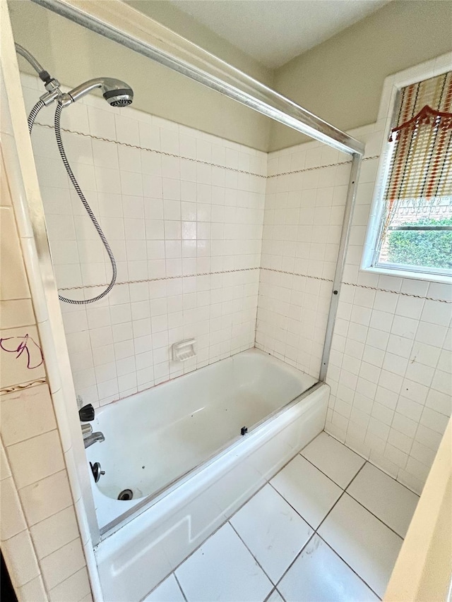 bathroom featuring shower / bath combination, tile patterned flooring, and tile walls