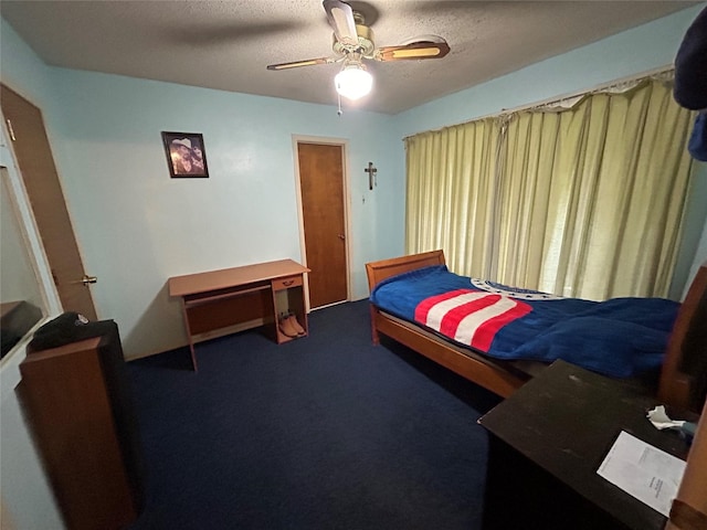 carpeted bedroom with ceiling fan and a textured ceiling