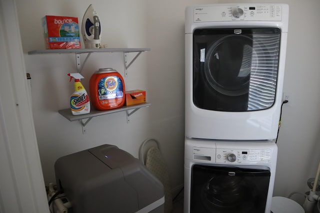 laundry area featuring laundry area and stacked washer / drying machine