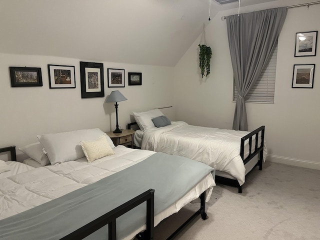 bedroom featuring lofted ceiling, light colored carpet, and baseboards