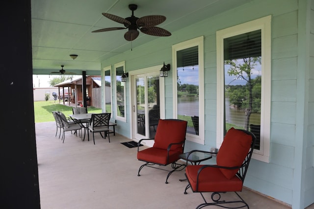 view of patio with outdoor dining area and a ceiling fan