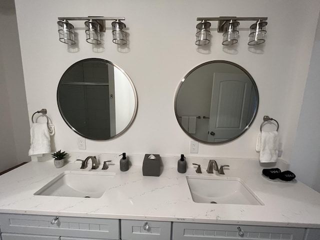 bathroom featuring a sink and double vanity