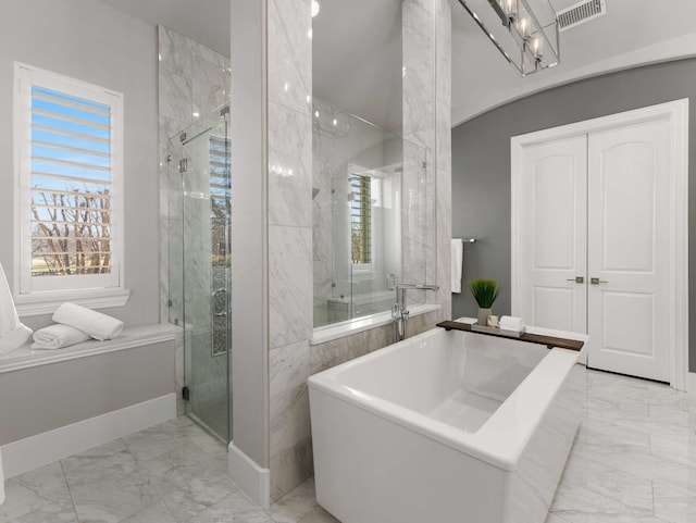 bathroom featuring visible vents, marble finish floor, and a shower stall