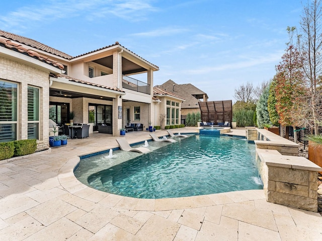 view of pool featuring a pool with connected hot tub and a patio