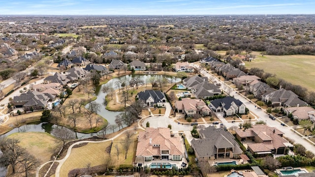 drone / aerial view featuring a residential view and a water view