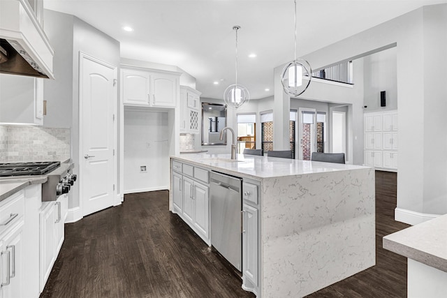 kitchen with dark wood-style flooring, custom exhaust hood, stainless steel appliances, white cabinetry, and a sink