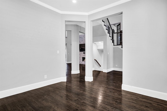 empty room with baseboards, stairway, wood finished floors, crown molding, and recessed lighting