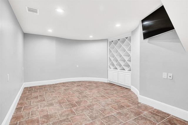 basement featuring recessed lighting, visible vents, and baseboards