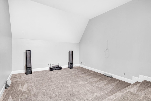 additional living space with carpet floors, vaulted ceiling, and baseboards