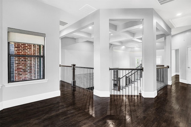 hall with attic access, baseboards, an upstairs landing, and wood finished floors