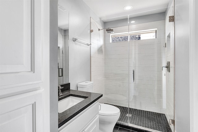 bathroom with toilet, a stall shower, tile patterned floors, and vanity