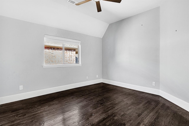 unfurnished room with ceiling fan, vaulted ceiling, baseboards, and dark wood finished floors