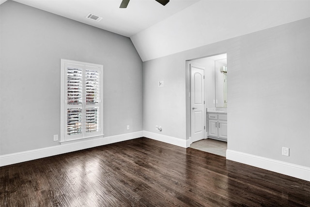 unfurnished bedroom featuring lofted ceiling, baseboards, visible vents, and wood finished floors