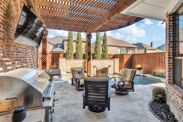 view of patio featuring a fenced backyard, an outdoor kitchen, a pergola, and area for grilling