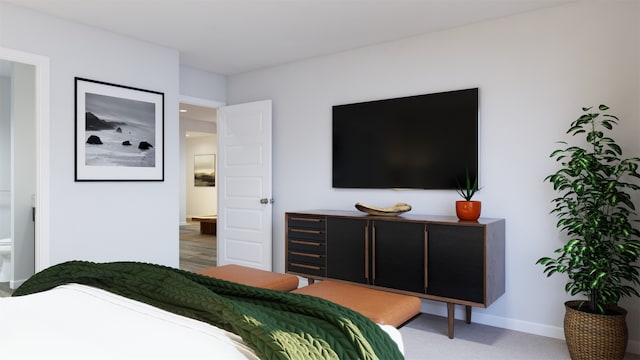 bedroom featuring light carpet and baseboards