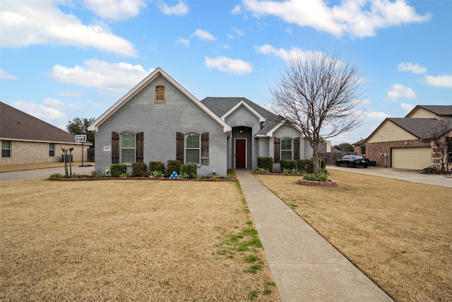 french provincial home featuring brick siding and a front lawn