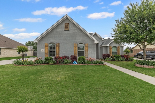 view of front of property with brick siding and a front yard