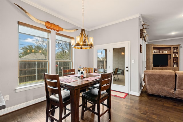 dining area with crown molding, baseboards, an inviting chandelier, and dark wood-type flooring