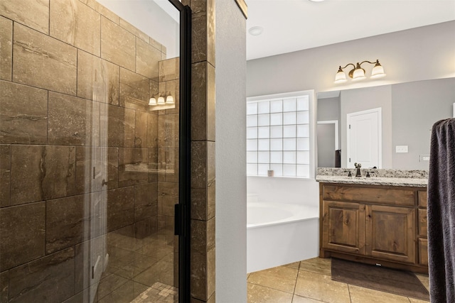 full bathroom featuring a stall shower, a garden tub, vanity, and tile patterned floors