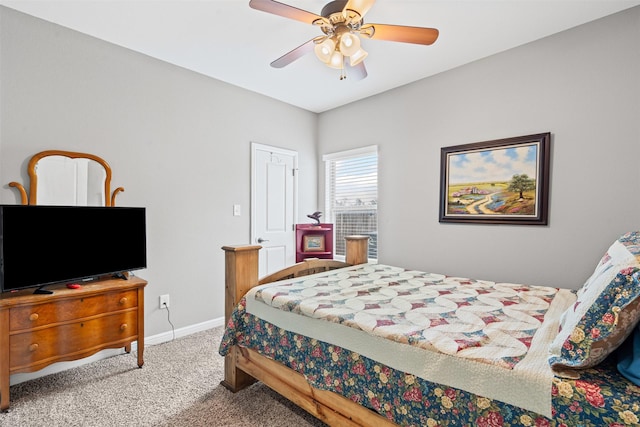 carpeted bedroom featuring a ceiling fan and baseboards