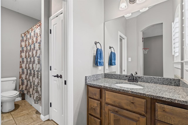 bathroom featuring vanity, baseboards, curtained shower, and toilet