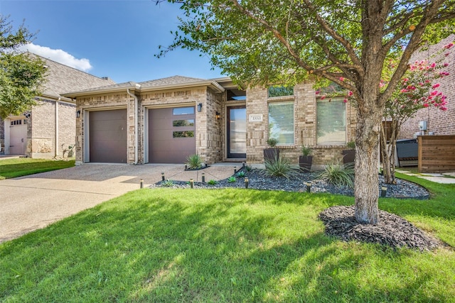 view of front of house with a garage, a front yard, concrete driveway, and brick siding