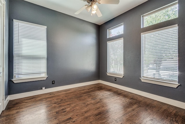 spare room featuring a ceiling fan, baseboards, and wood finished floors