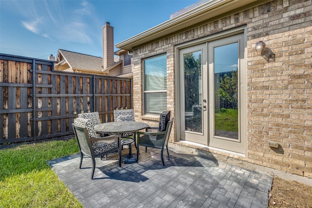 view of patio / terrace with fence, french doors, and outdoor dining space