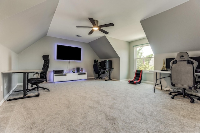 carpeted office space featuring visible vents, baseboards, vaulted ceiling, and a ceiling fan