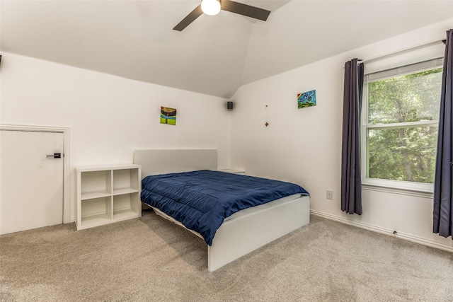 carpeted bedroom with lofted ceiling and a ceiling fan