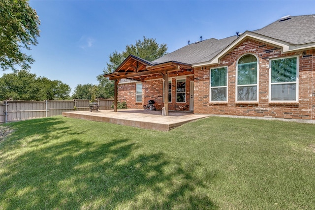 back of property with a patio area, brick siding, and a fenced backyard