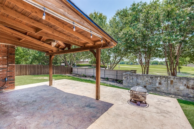 view of patio / terrace featuring an outdoor fire pit and a fenced backyard