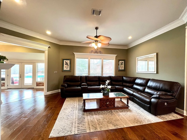 living room featuring plenty of natural light, visible vents, wood finished floors, and french doors