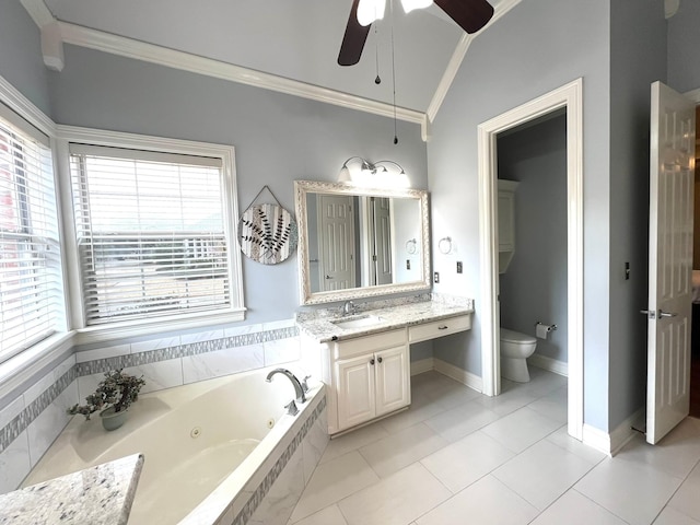 bathroom featuring toilet, ornamental molding, vaulted ceiling, vanity, and a jetted tub