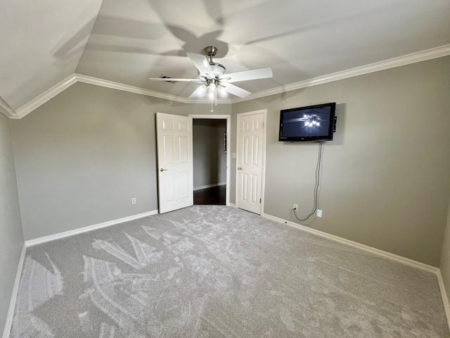 unfurnished bedroom featuring ceiling fan, ornamental molding, carpet flooring, and baseboards