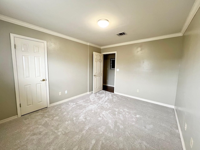 spare room featuring crown molding and baseboards