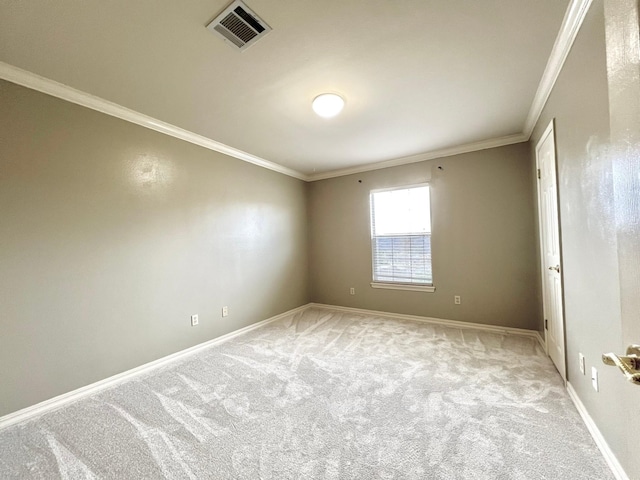 empty room featuring baseboards, visible vents, crown molding, and light colored carpet