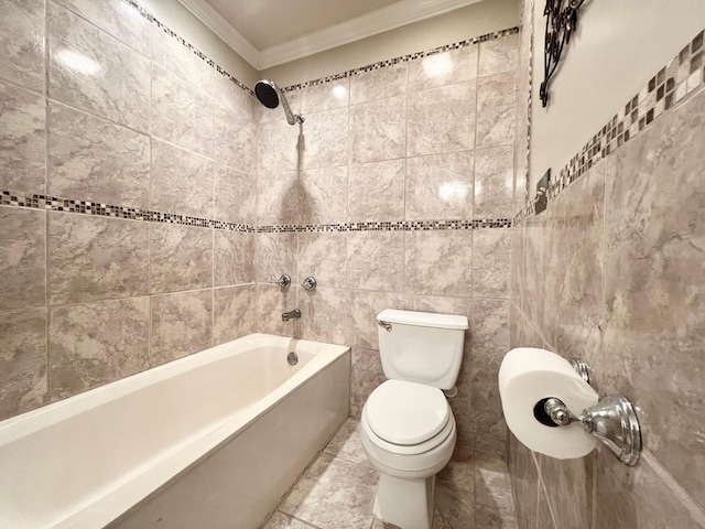 bathroom with toilet, tile walls, crown molding, and shower / bathing tub combination