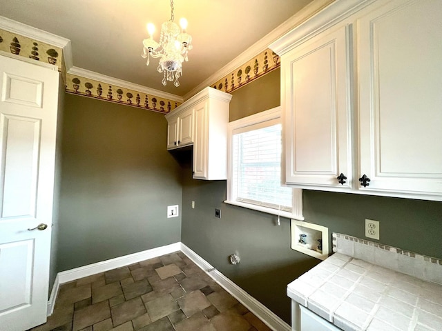 laundry area featuring ornamental molding, cabinet space, electric dryer hookup, and baseboards