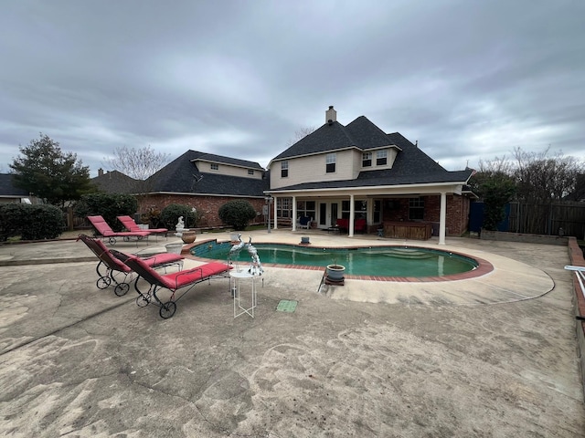 view of pool featuring fence, a fenced in pool, and a patio