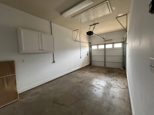 garage featuring baseboards and a garage door opener