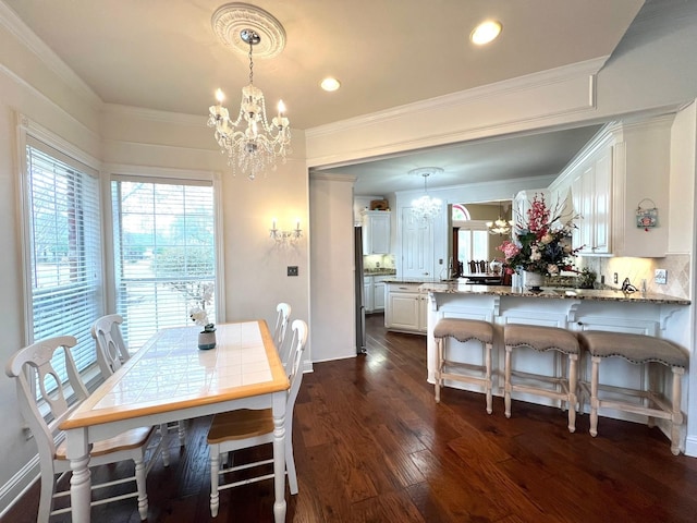 dining room with dark wood-style floors, baseboards, a chandelier, and ornamental molding