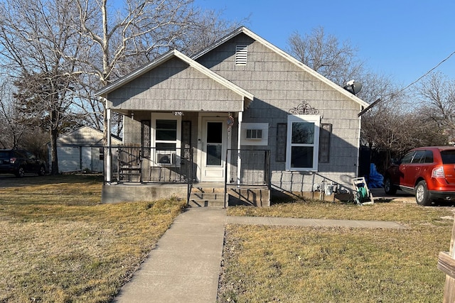 bungalow-style house with covered porch and a front yard