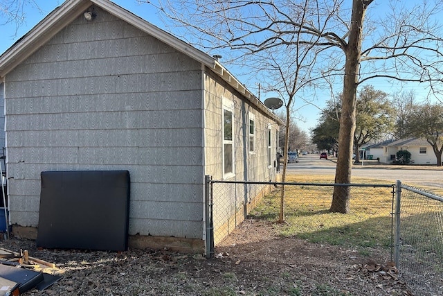 view of side of property featuring fence