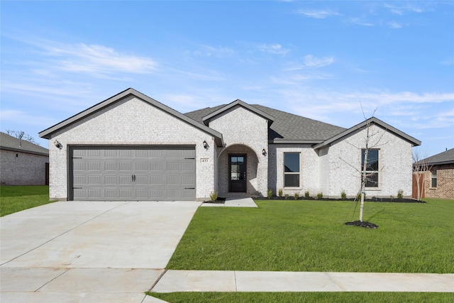 view of front of home with a front yard, a shingled roof, concrete driveway, a garage, and brick siding