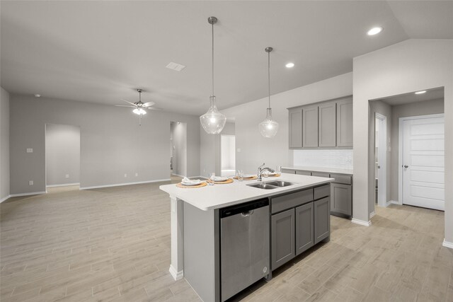 kitchen with a sink, dishwasher, gray cabinets, and light countertops