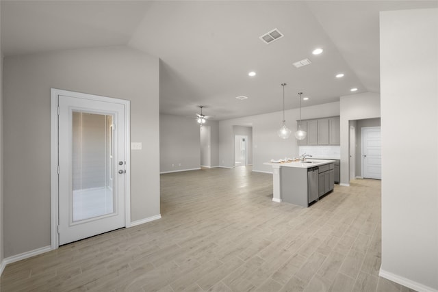 kitchen featuring visible vents, gray cabinets, light countertops, light wood-style floors, and open floor plan