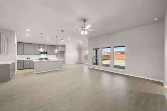 433 Falcon, Azle, TX 76020 - unfurnished living room with recessed lighting, visible vents, light wood-style floors, baseboards, and ceiling fan